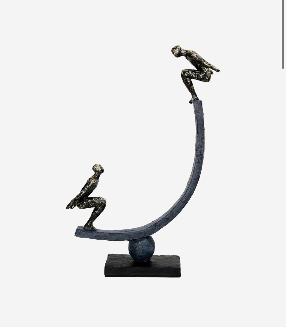 Balancing act figures sculpture with bronze finish and abstract design