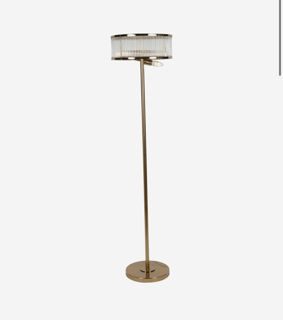 Beaumont floor lamp in antique brass with glass crystal rods emitting warm ambient light