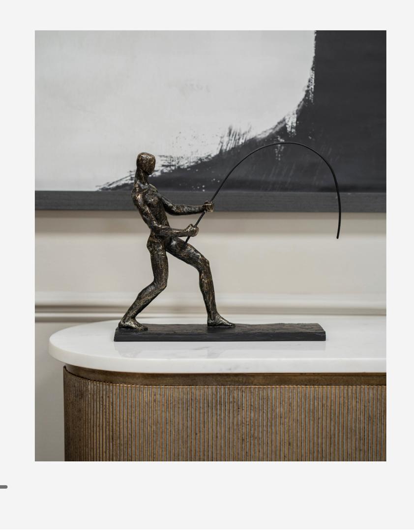 Fishing sculpture on stand in bronze finish with fisherman figure