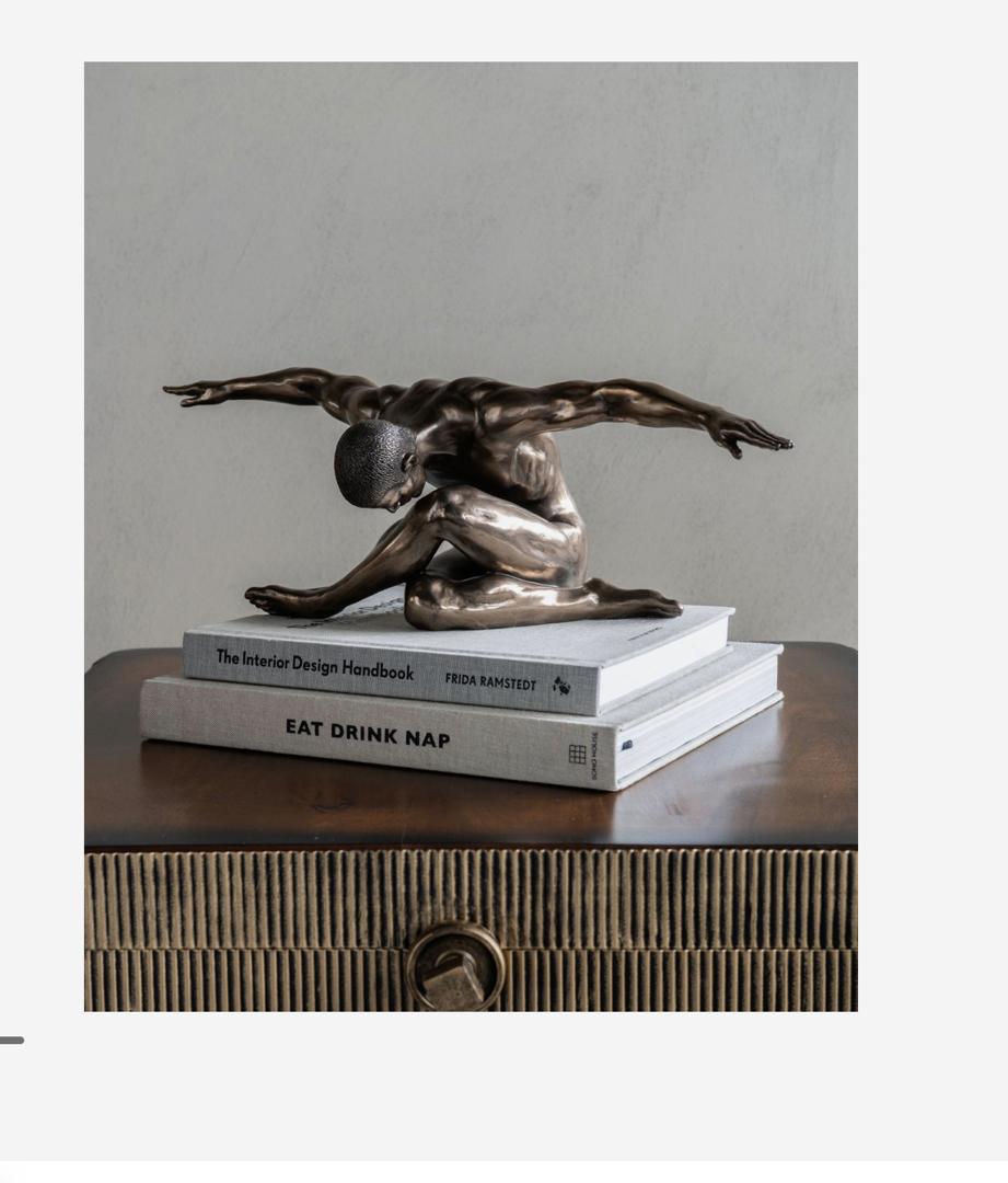 Keswick male sculpture with arms outstretched in bronze finish