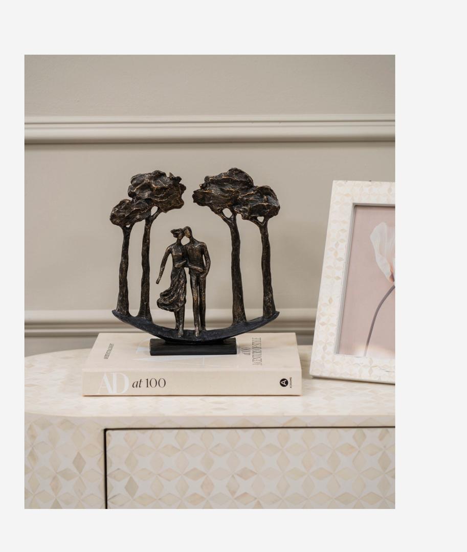 Lovers arboretum sculpture with couple and trees in bronze finish