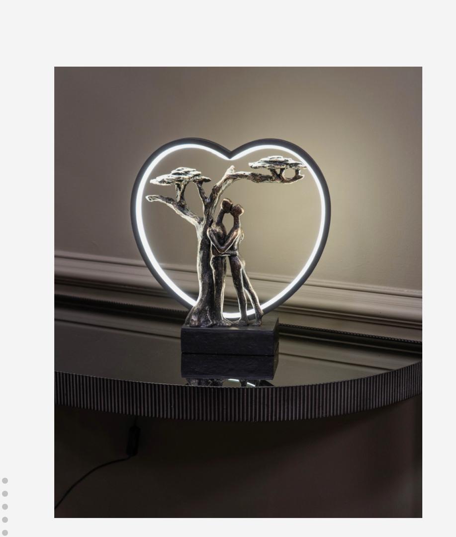 Loving couple LED sculpture with heart light and bronze finish