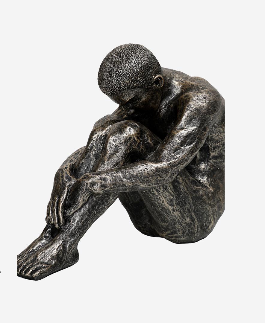 Relaxed male sculpture in bronze textured finish
