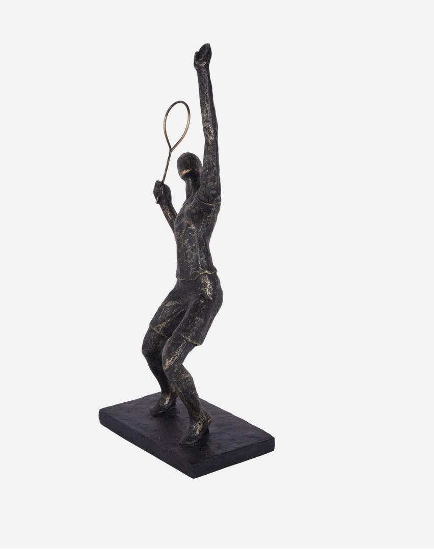 Tennis player sculpture in bronze mid serve pose
