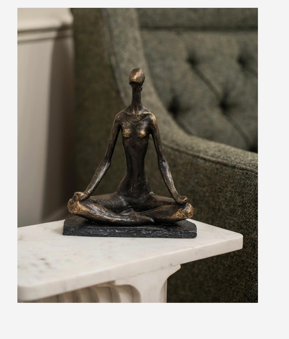 Yoga pose sculpture in bronze finish with serene female figure